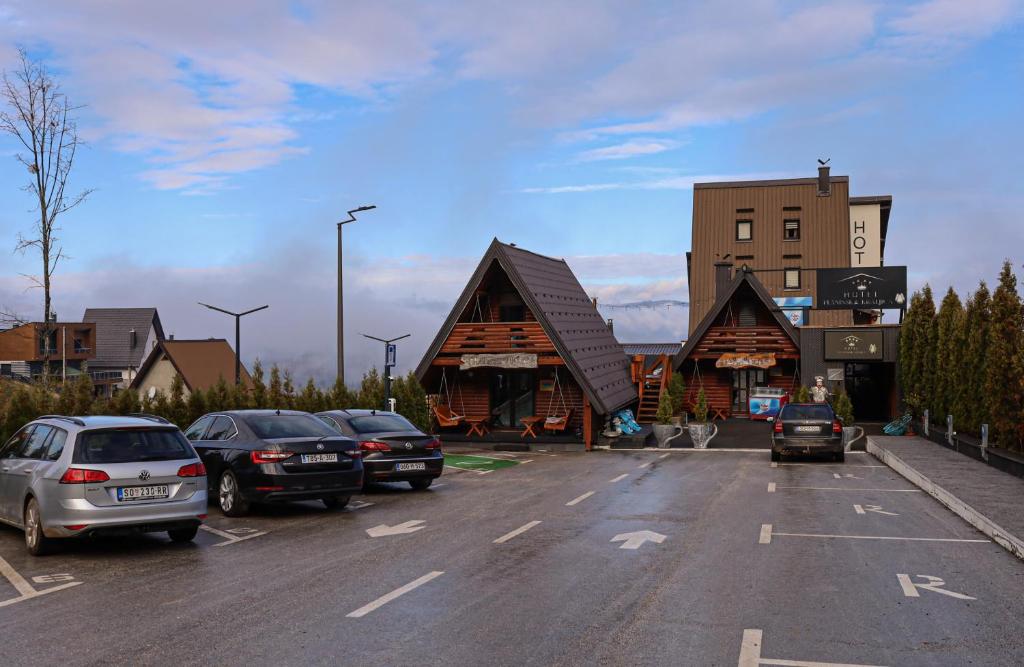 a parking lot with cars parked in front of buildings at Planinska Kraljica in Gornje Pale