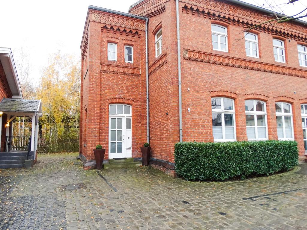 a brick building with a white door on the side of it at Qonroom - as individual as you - Oeynhausen City in Bad Oeynhausen