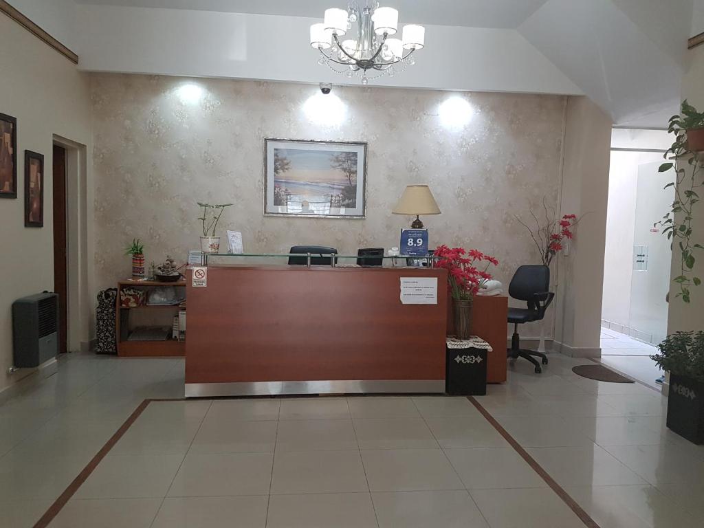 a lobby with a reception desk in a building at San Carlos Hotel in Buenos Aires