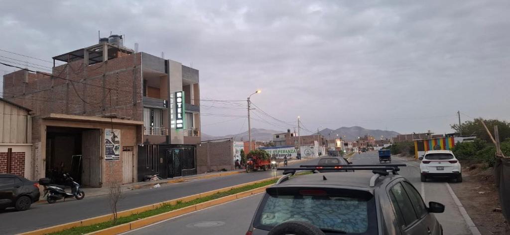 a city street with cars parked on the road at Hotel Nueva Vista Huarmey in Huarmey