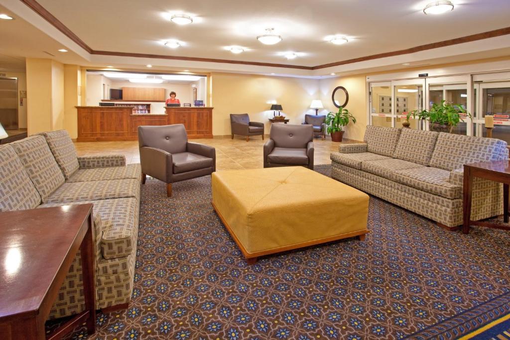 a hotel lobby with couches and chairs and a table at Candlewood Suites Roswell by IHG in Roswell