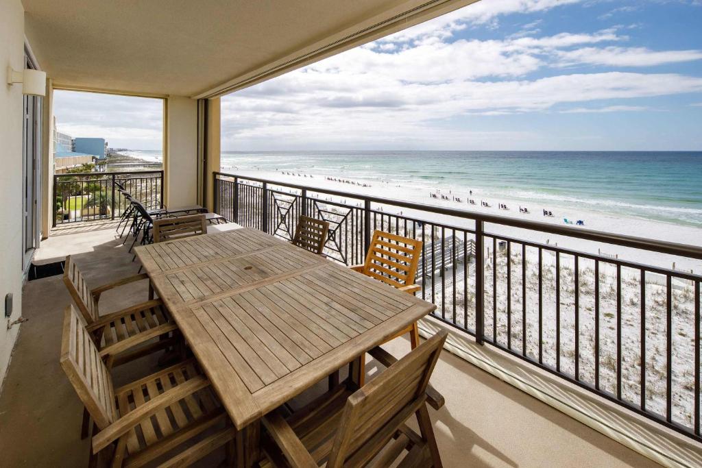 a balcony with a table and chairs and the beach at Bella Riva 301 Large Gulf Front condo in Fort Walton Beach