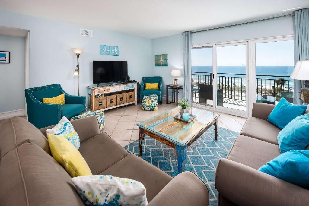 a living room with a couch and a table at Emerald Isle 610 Beach Front condo in Fort Walton Beach
