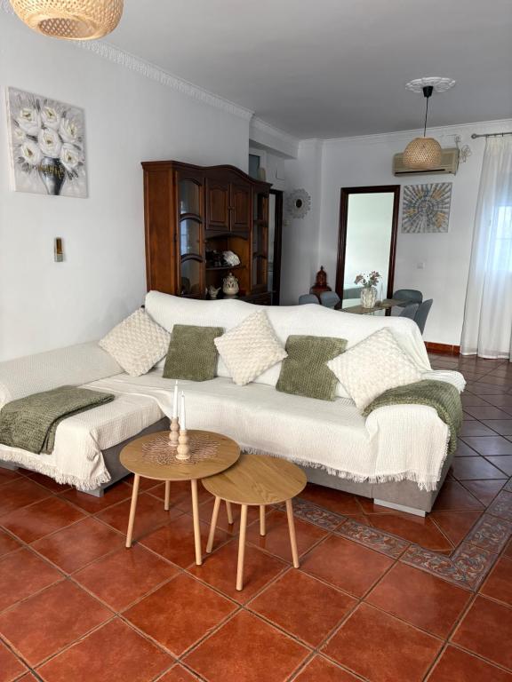a living room with a large bed and a table at Casa Rural Moreno in Setenil
