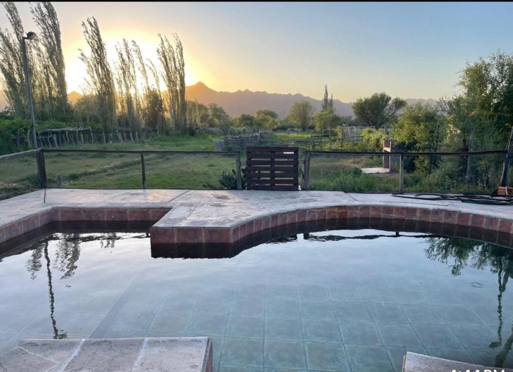 a pool of water in a yard with a fence at Hosteria Huaco in Huaco