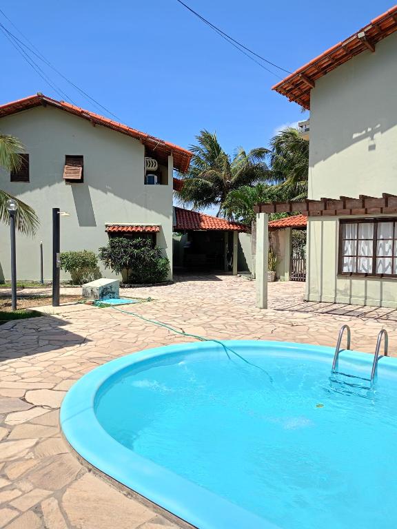 a swimming pool in front of a building at CASA de 02 suítes e 1 quarto, piscina e churrasqueira "casa maré alta" in Barra de São Miguel