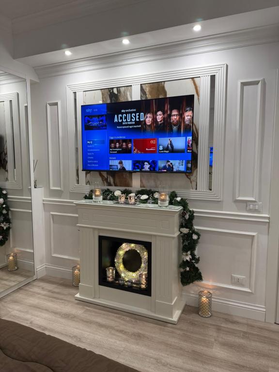 a living room with a fireplace and a tv at 6 AL TOP in Rome