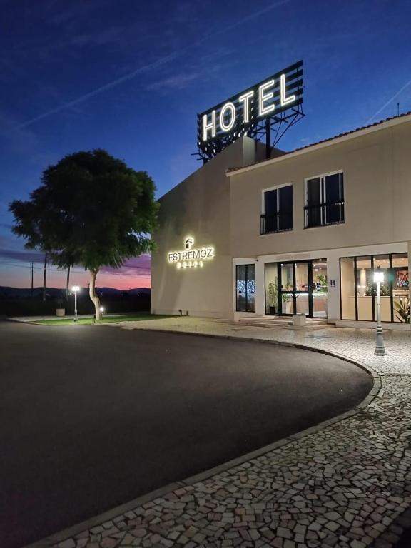 a hotel building with a sign on top of it at Estremoz Hotel in Estremoz