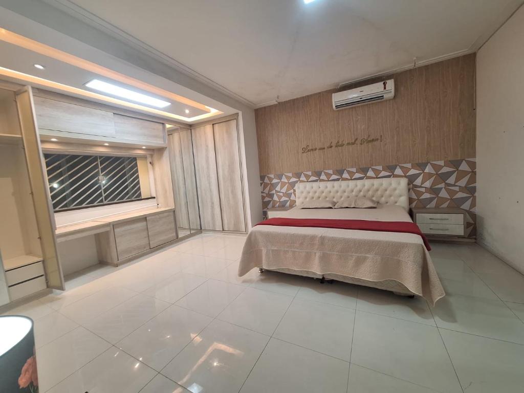 Giường trong phòng chung tại Casa de Temporada Reluz