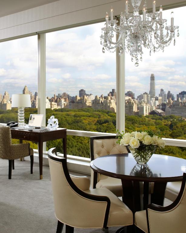 a dining room with a chandelier and a table and chairs at Trump International New York in New York