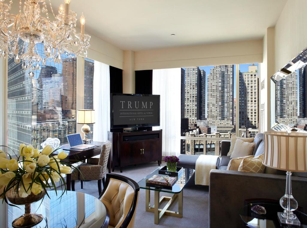 a living room with a couch and a tv at Trump International New York in New York