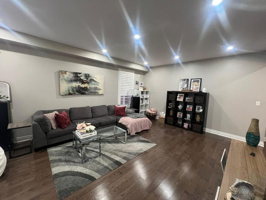 a living room with a couch and a table at Luxury 5BR Home with Spa Bath in Burlington