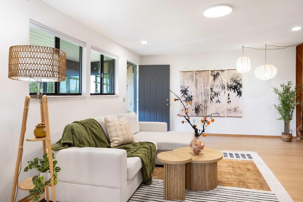 a living room with a white couch and a table at Bellevue Somerset 2BR w Sunroom & Sweeping Views in Newcastle