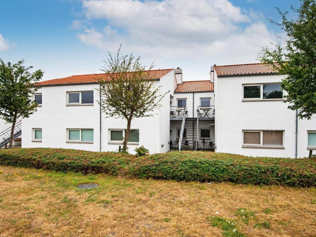 a large white house with a yard at Bright Seaside Apartment in Ebeltoft in Ebeltoft
