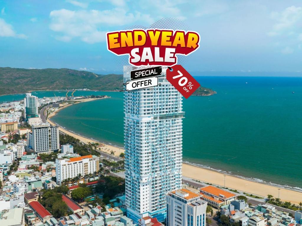 a sign on top of a building on a beach at TMS Beachfront Quy Nhon Apartment in Quy Nhon