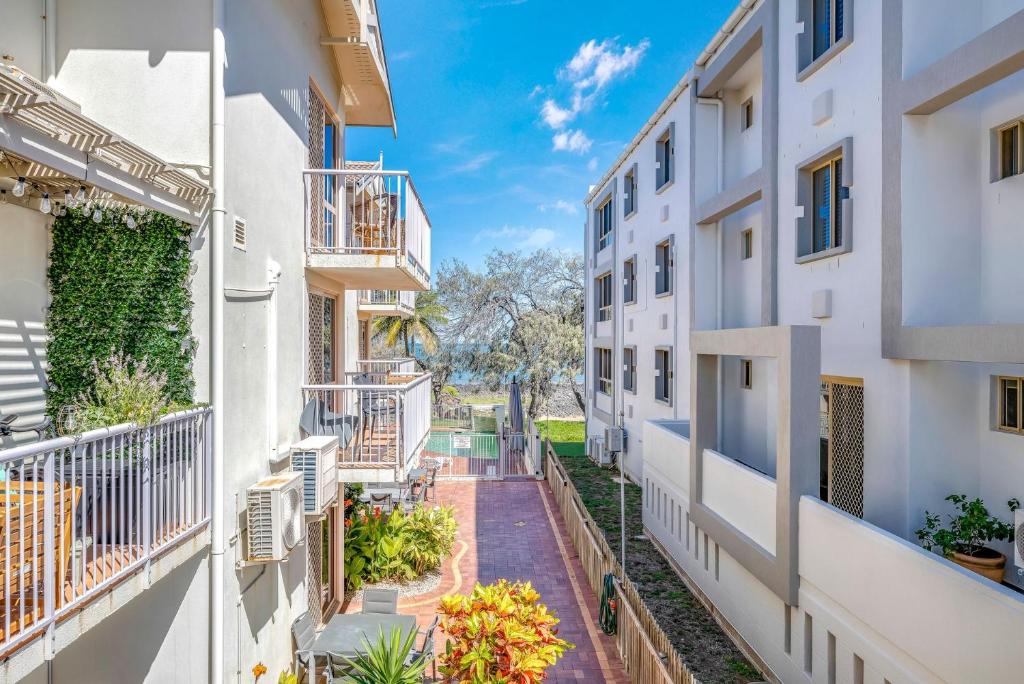 an apartment building with balconies and plants at Shoreline Apartments - Unit 4a in Bargara