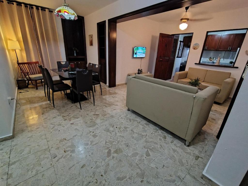 a living room with a couch and a table at Comfortable and quiet double room in Santo Domingo