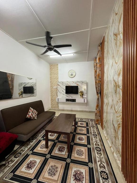 a living room with a couch and a table at HOMESTAY AYER MOLEK Malay ONLY in Air Molek