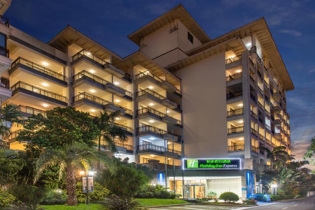 an apartment building at night with its lights on at Holiday Inn Express Haikou West Coast by IHG in Haikou