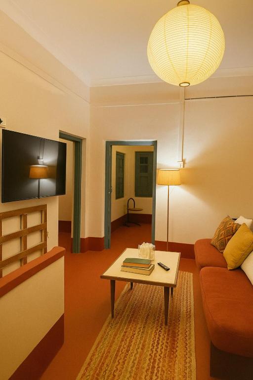 a living room with a couch and a table at Classic Jayanagar House for Veg only in Bengaluru