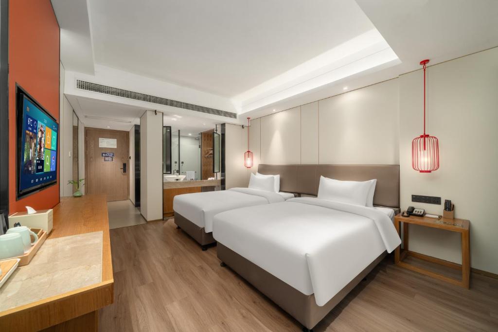 Ένα ή περισσότερα κρεβάτια σε δωμάτιο στο Kaiyuan Mingting Hotel, near Gulou Metro Station, Tianyi Square, Ningbo