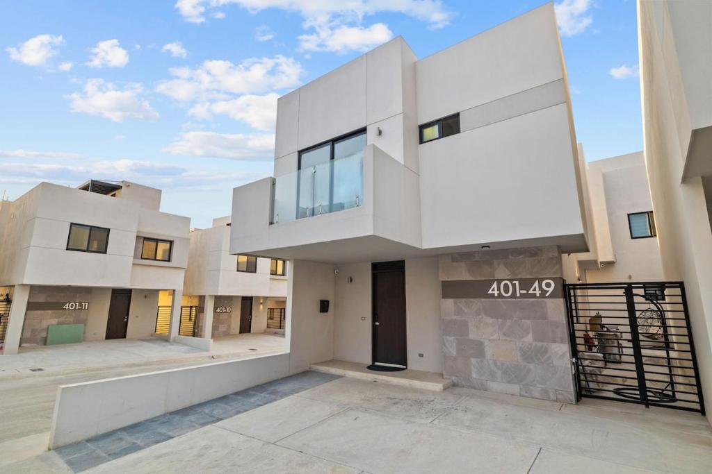 a large white building with a balcony on a street at Playas de Tijuana in Tijuana
