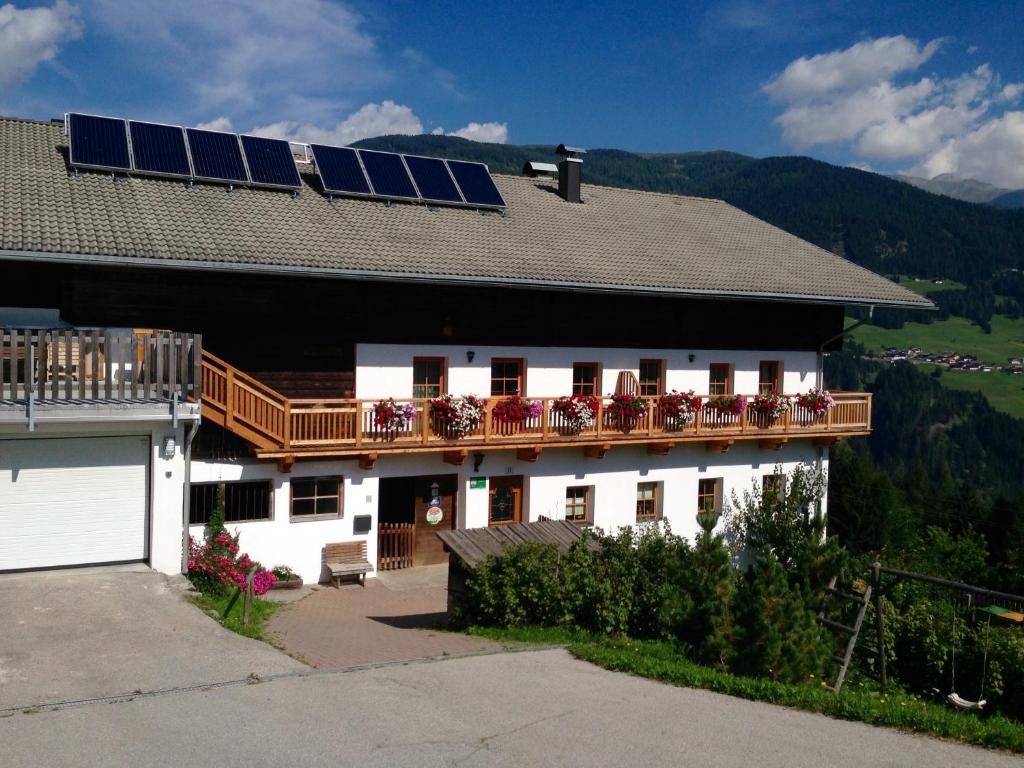 a house with solar panels on the roof at Bleierhof Apartment in Kartitsch