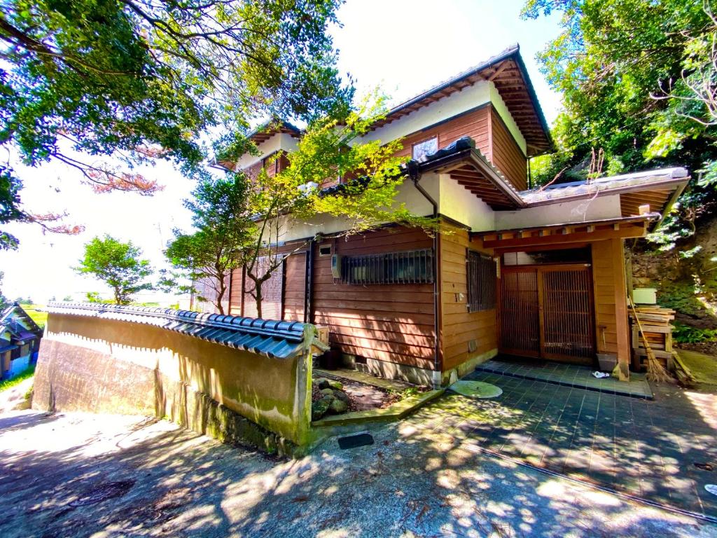 a house with a fence in front of it at 海の宿mare in Hakui