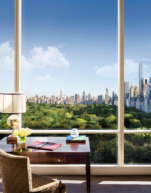 a room with a desk and a large window at Trump International New York in New York