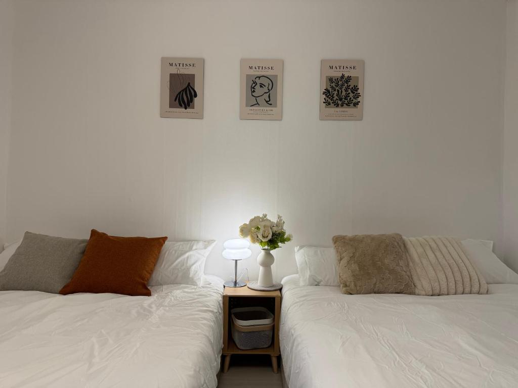 two beds sitting next to each other in a room at Won-Stay in Samgong