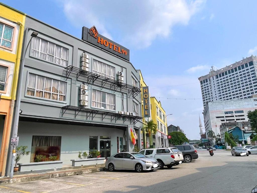 a building with cars parked outside of it on a street at Hotel 99 Bandar Klang (Meru) in Klang