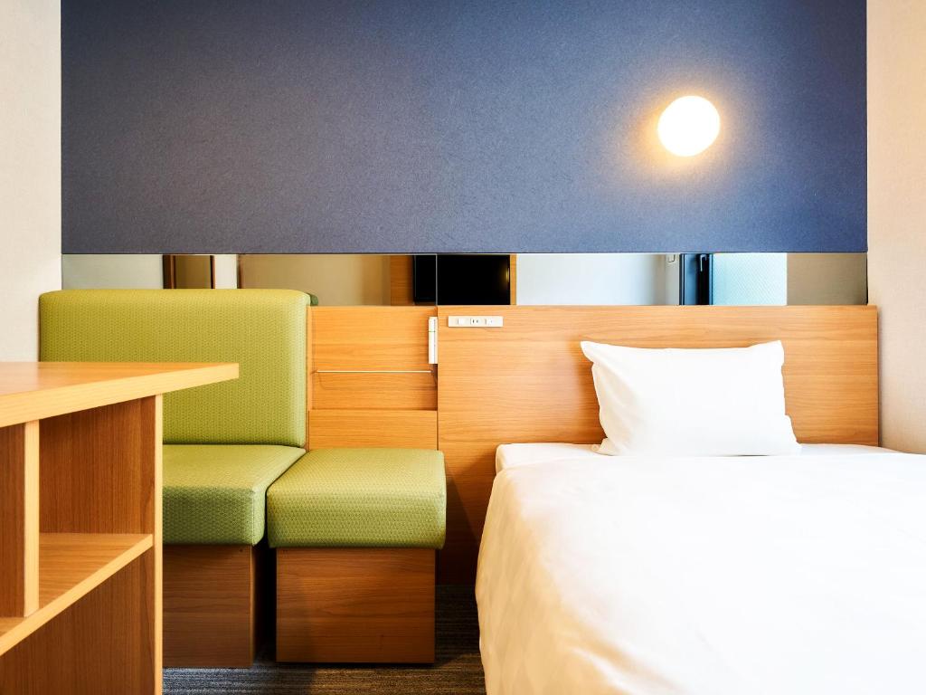 a hotel room with a bed and a desk and a table at Rakuten STAY URBAN Kyoto Shijo Omiya in Kyoto
