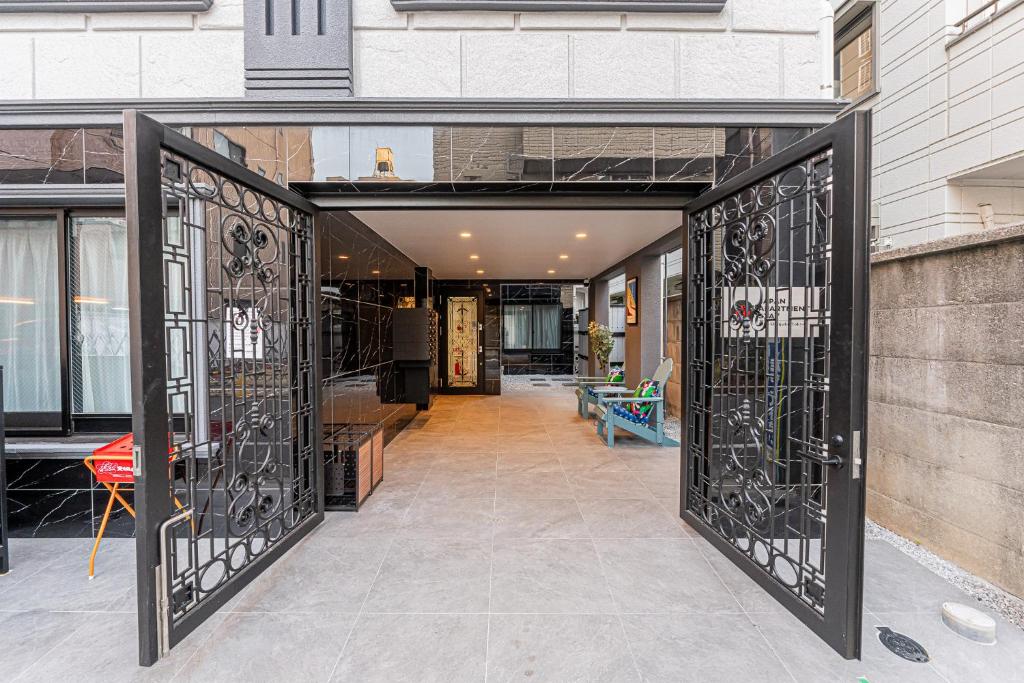 an open door of a building with wrought iron gates at Mi-Hotel Kitashinjuku 北新宿 in Tokyo
