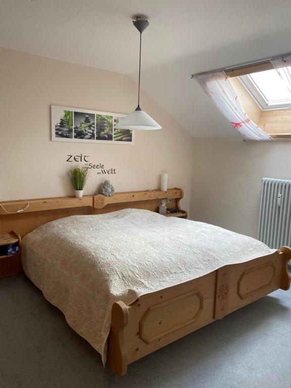 a bedroom with a wooden bed in a room at Ferienwohnung Falkensteinblick in Pfronten