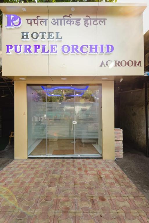 a store front with a sign for a hotel purple orbital at Hotel Purple Orchid in Mumbai