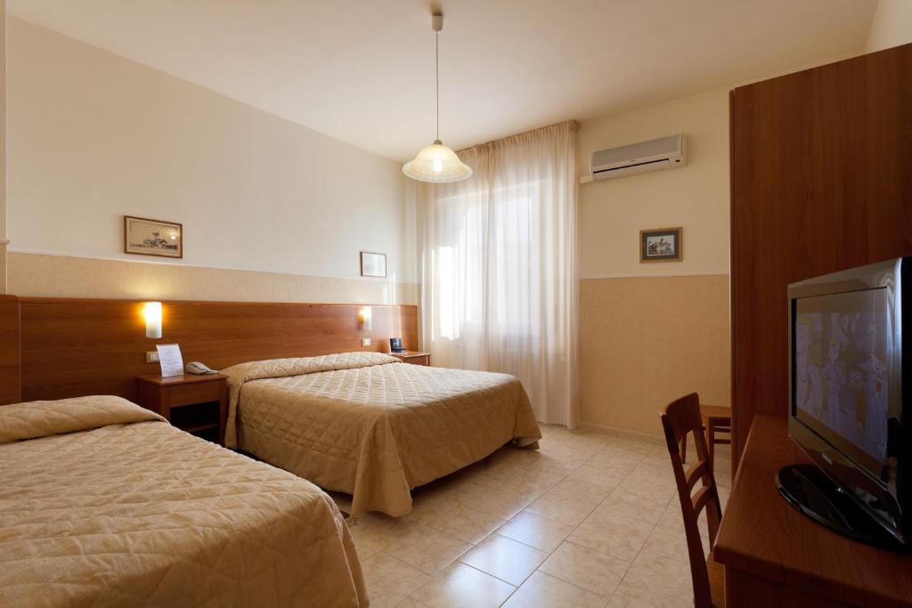 A bed or beds in a room at Parking Hotel Giardino