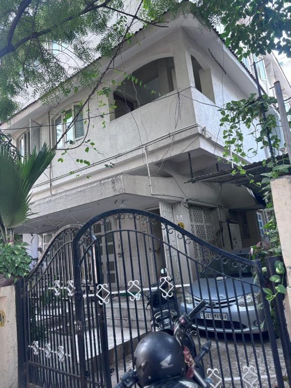 a black motorcycle parked in front of a house at Krushna Boys Pg in Ahmedabad