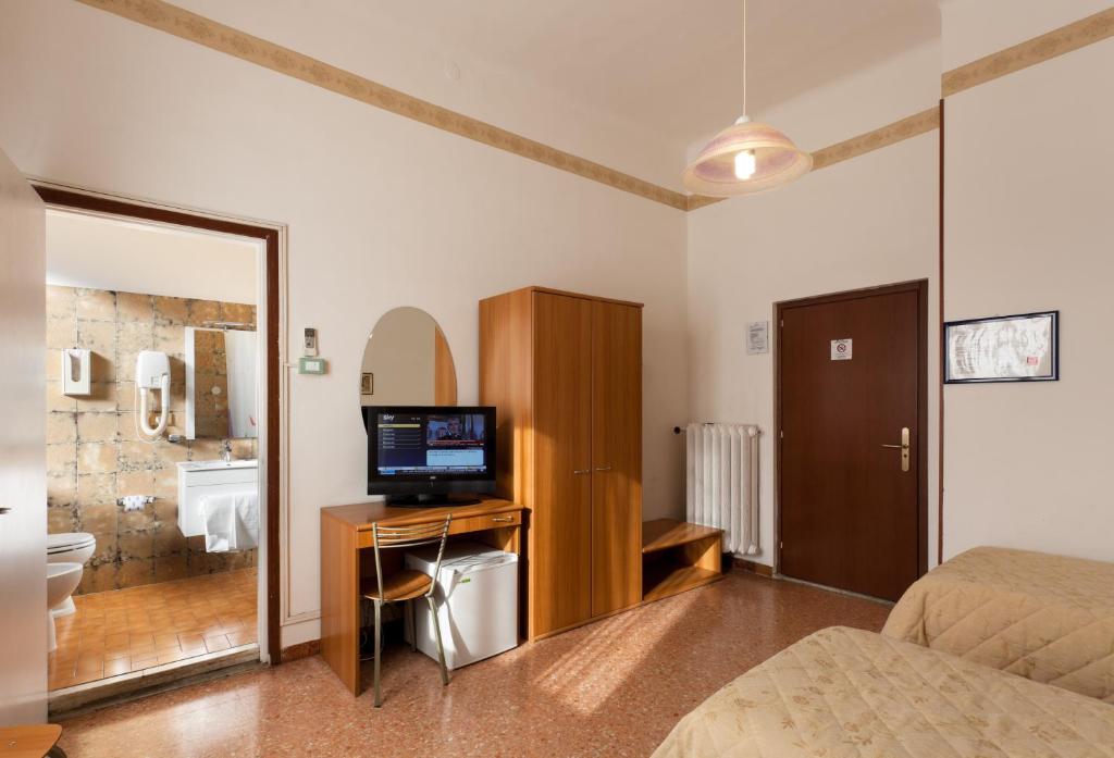 A bed or beds in a room at Parking Hotel Giardino