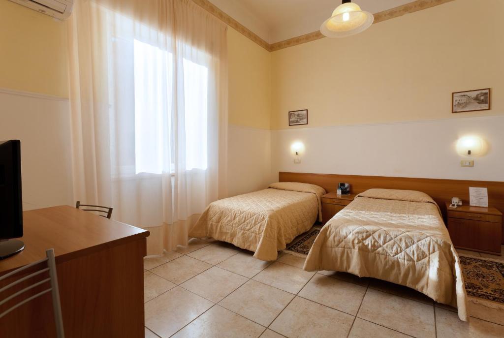 A bed or beds in a room at Parking Hotel Giardino