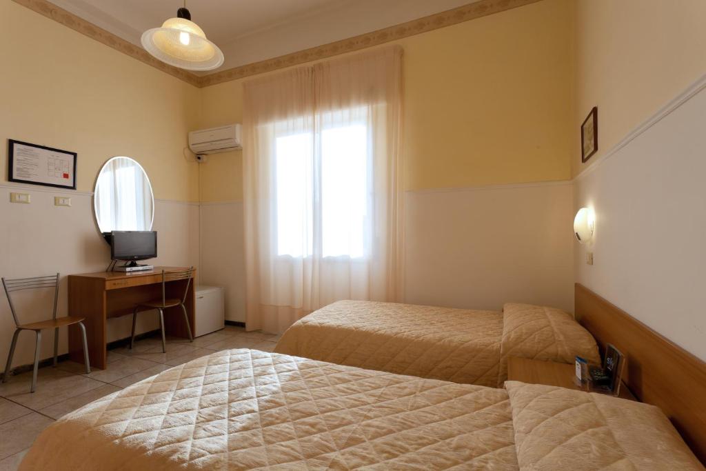 A bed or beds in a room at Parking Hotel Giardino
