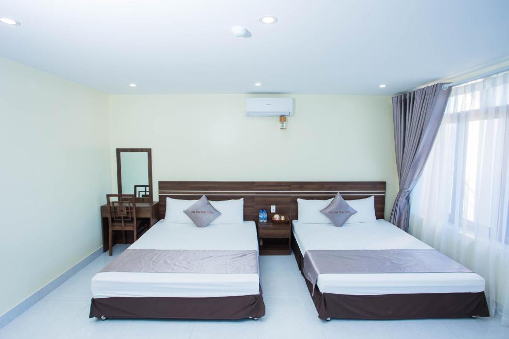 Giường trong phòng chung tại Naka Hotel Mộc Châu - Lầu Anh Thái