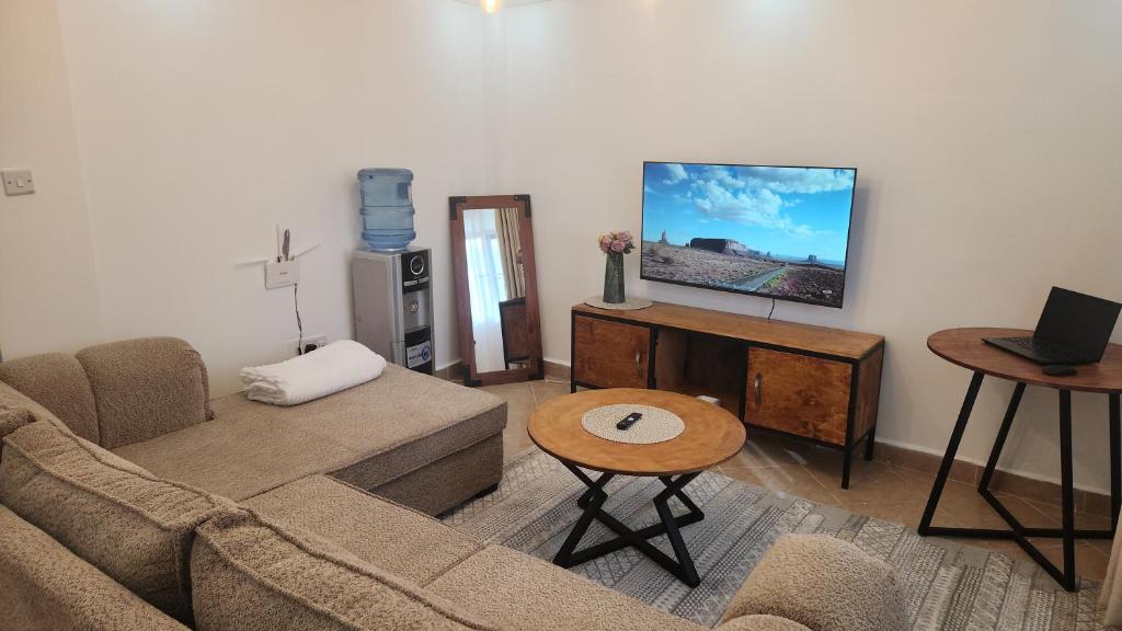 a living room with a couch and a tv at Naivasha Naivegas C5 Staycation by Charlie izzy in Munyu