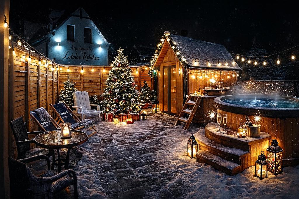 a patio with a christmas tree and lights at Apartamenty Zatoka Relaksu Sauna i Balia in Polańczyk