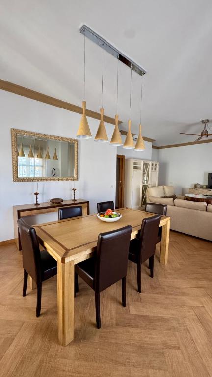 a living room with a wooden table and chairs at Galteo Remedios in Ronda
