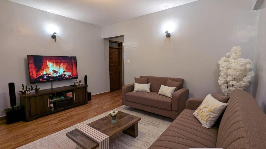 a living room with a couch and a tv at you are most welcome, feel at home in Makomboki