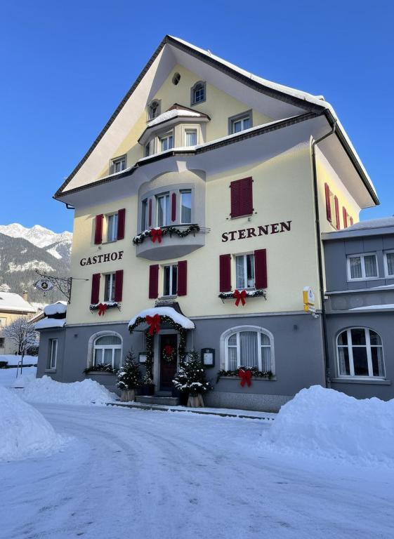a large white building with christmas decorations on it at Hotel Sternen in Gurtnellen