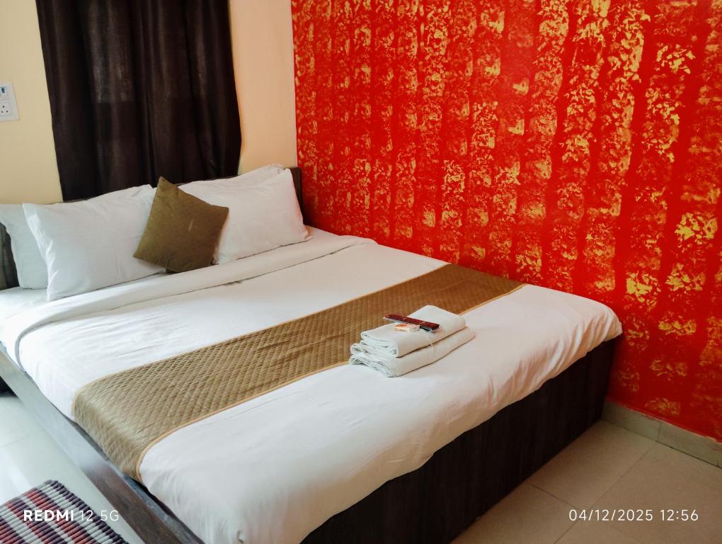 a hotel room with a bed with towels on it at Rathore Inn in Hāora
