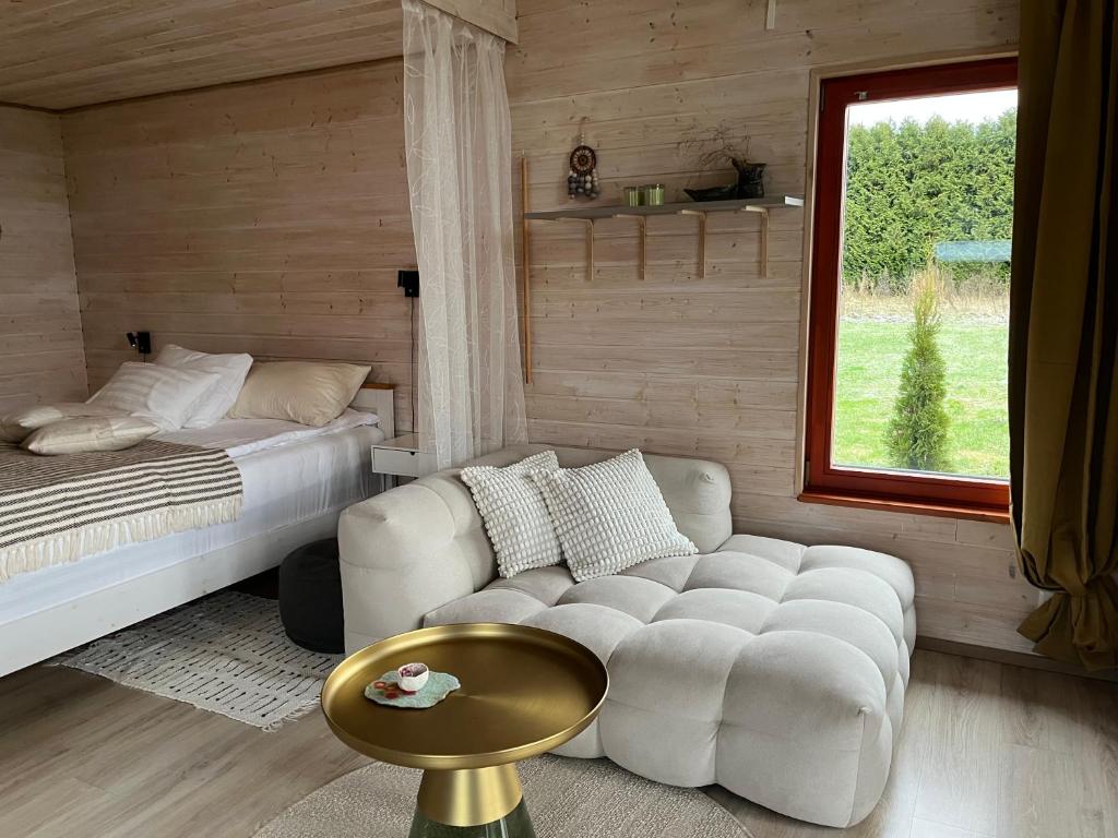 a living room with a couch and a bed at Beachboog LAHEMAA in Kuusalu