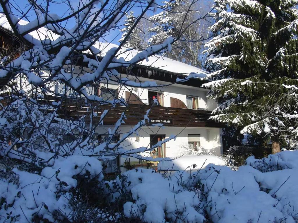 a house in the snow with snow covered trees at Ferienwohnung Konzell in Konzell