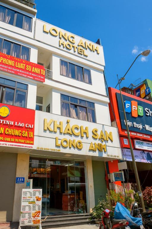 a building with signs on the side of it at Long Anh Hotel in Lao Cai